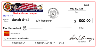 image of large-scale mock check presented to previous scholarship recipient, Sarah Stoll